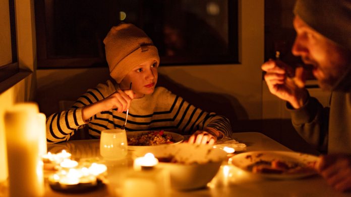 family eating by candlelight