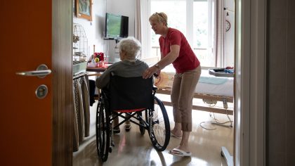 Caregiver and a senior woman in a wheelchair stock photo