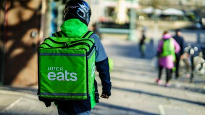 Uber eats delivery person carrying food to people who order by online