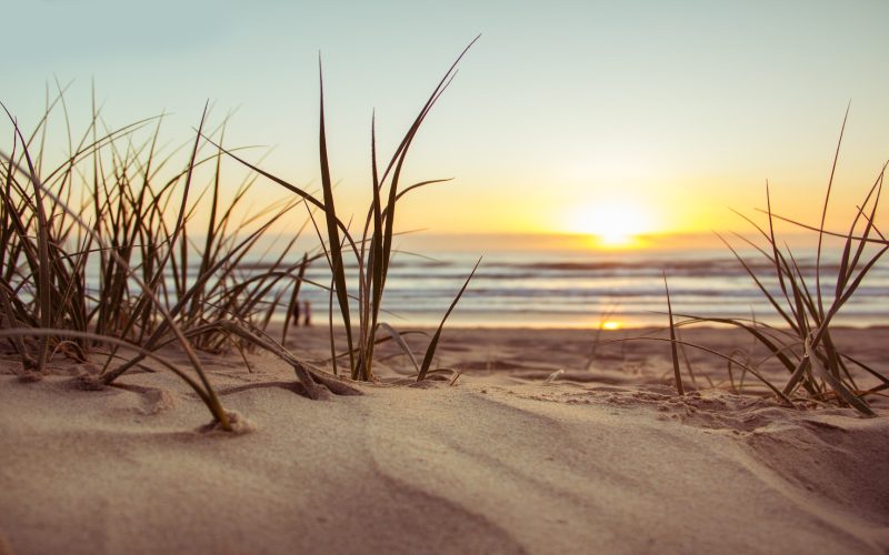 Early morning sun breaks light over the sand dunes