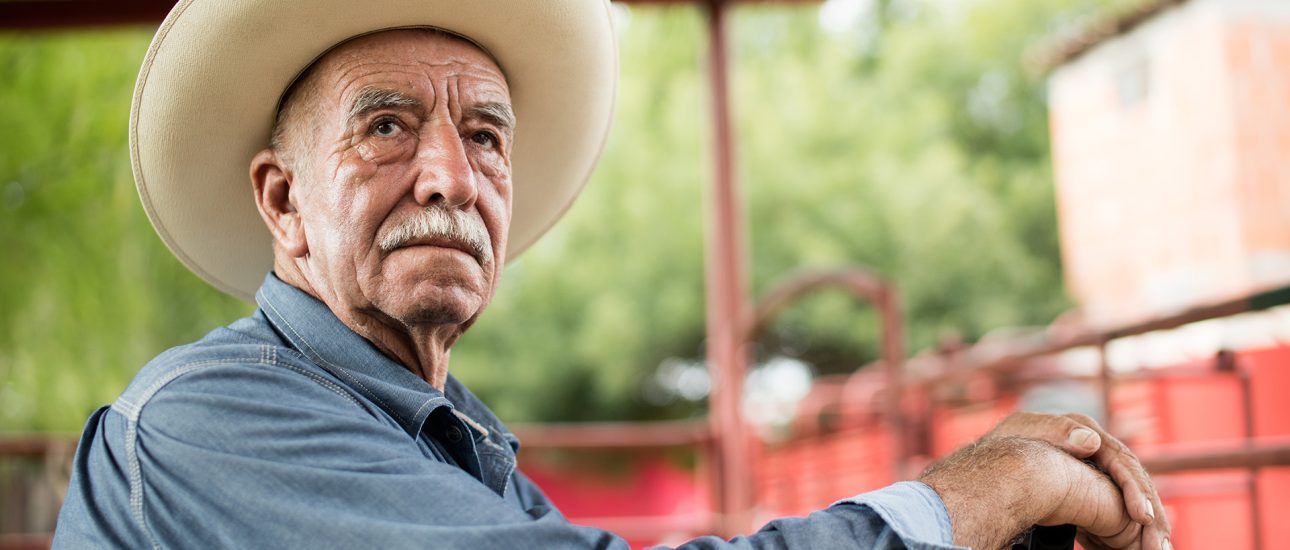 Older farmer on a tractor