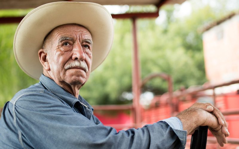 Older farmer on a tractor