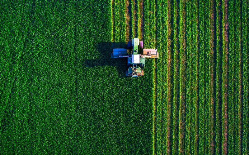 Tractor mowing green field