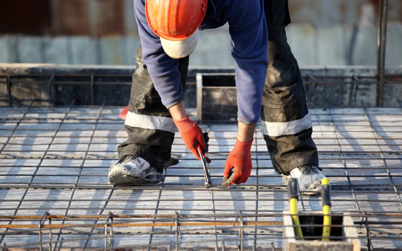 Worker at construction site with rebar