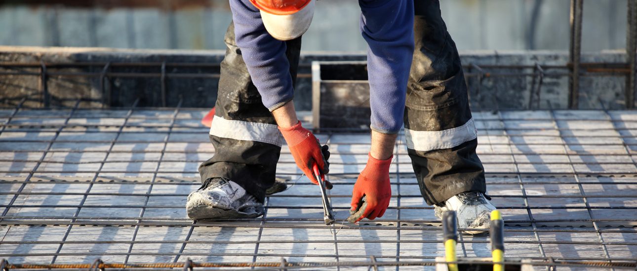 Worker at construction site with rebar