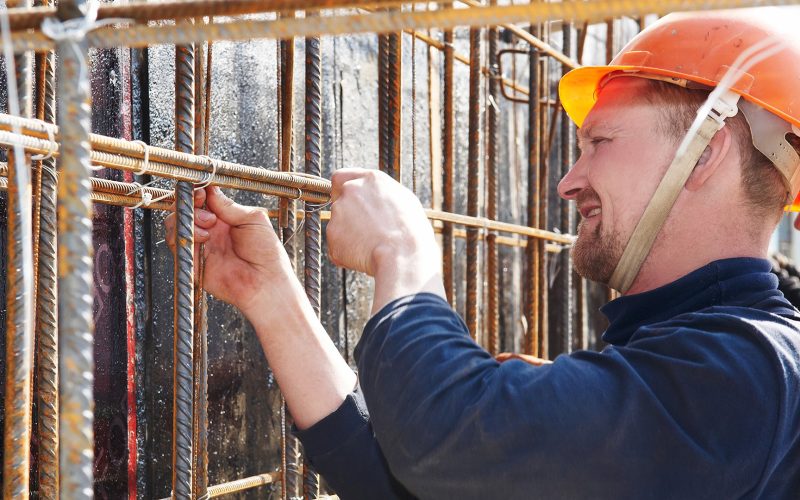 Construction worker tying rebar