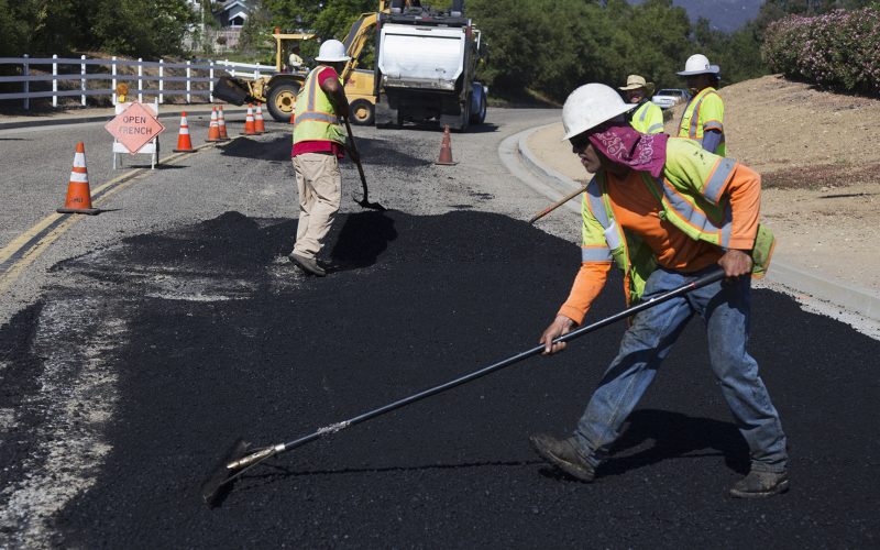 Construction Workers Paving Road