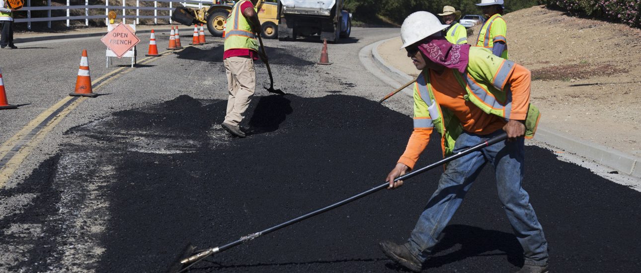 Construction Workers Paving Road