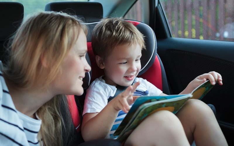 Mother and little son in the car reading