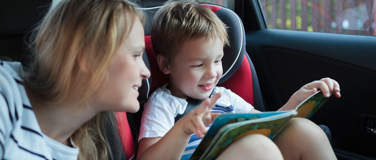 Mother and little son in the car reading