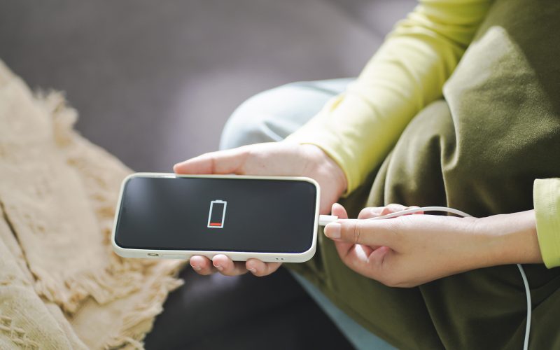 Woman charging cell phone