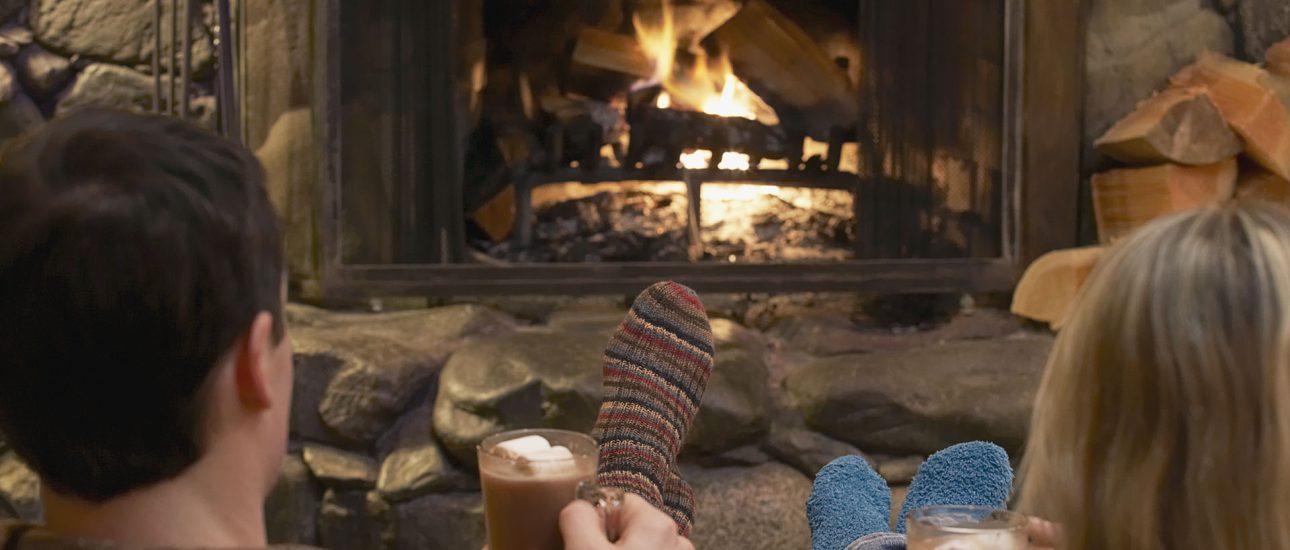 Couple relaxing by a fire