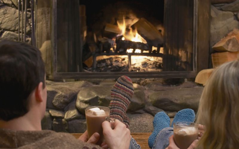 Couple relaxing by a fire