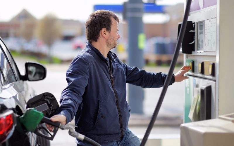 Man putting gas in car