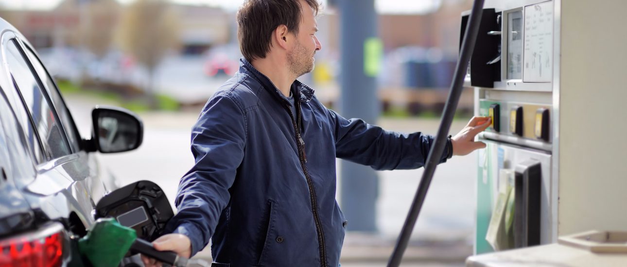 Man putting gas in car