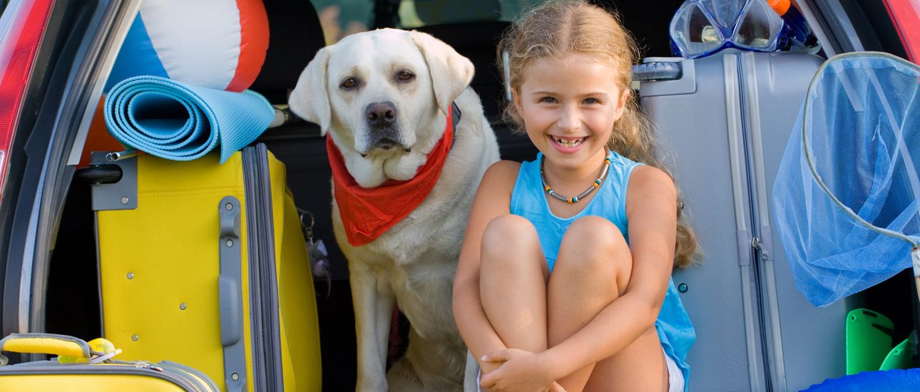 A girl with her Labrador getting ready for vacation