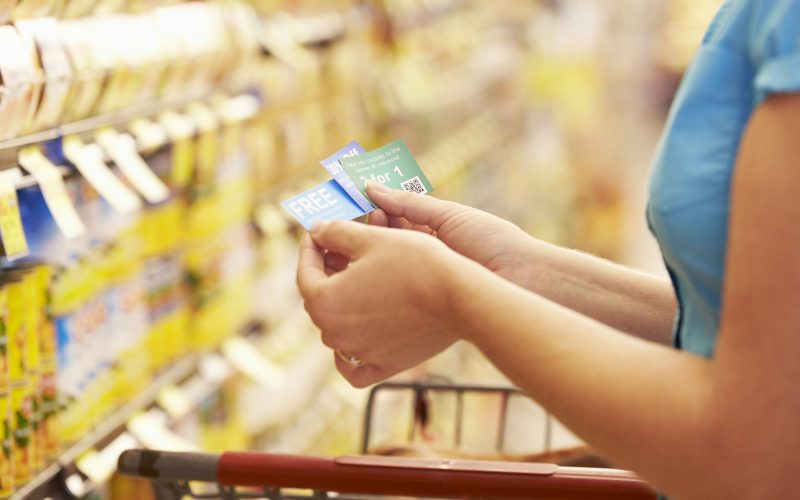 A woman checking her coupons in the store