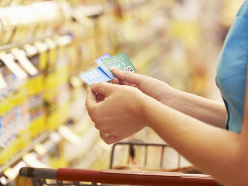 A woman checking her coupons in the store