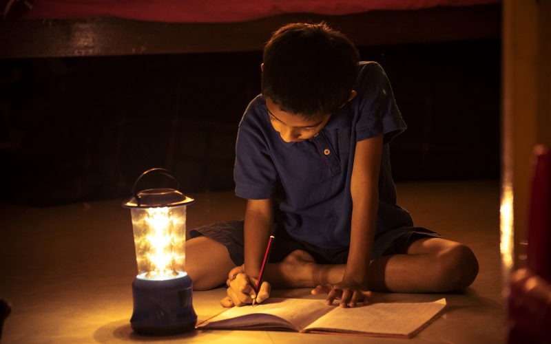 Child Doing Homework During Power Outage