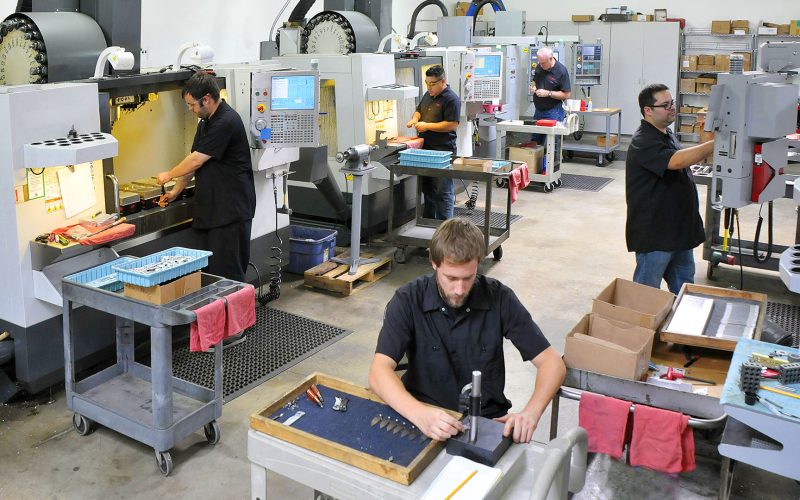 CNC machine shop with lathes, technicians and workers