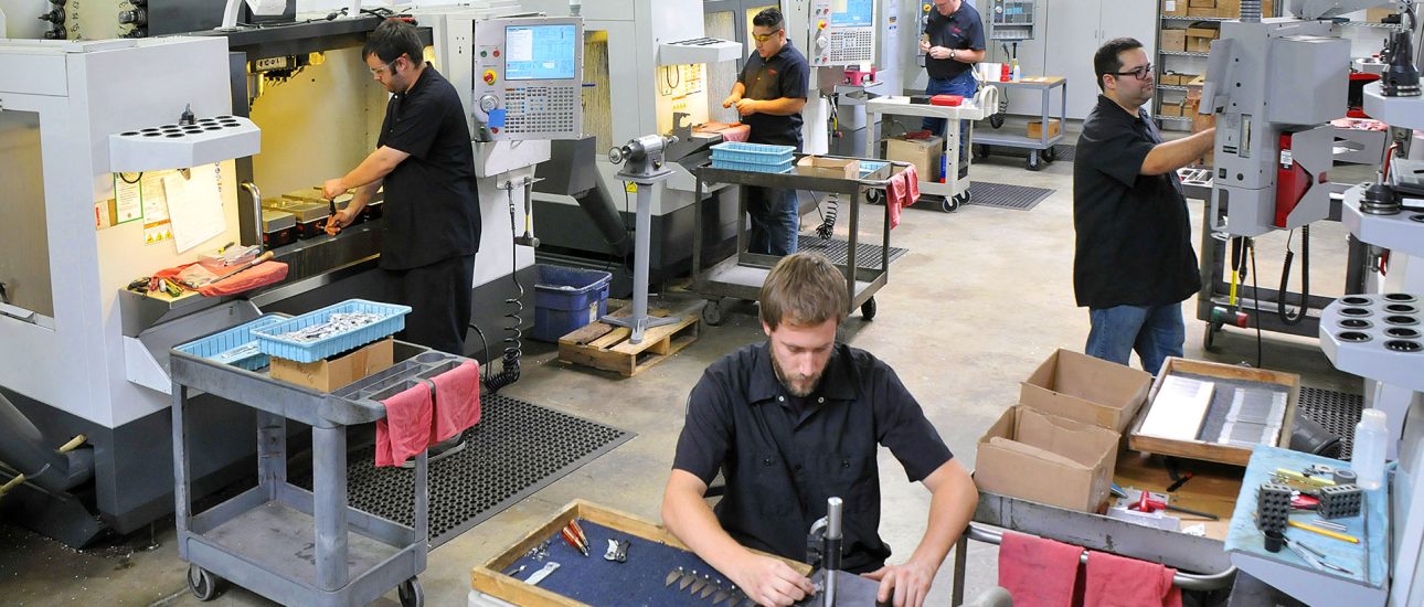 CNC machine shop with lathes, technicians and workers