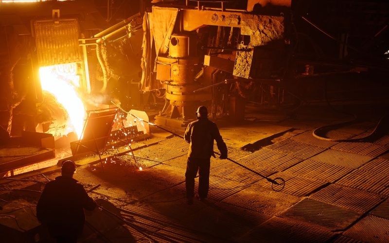 Steel mill worker over furnace