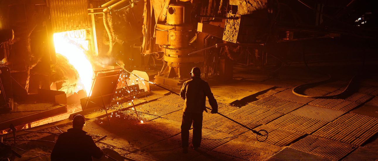 Steel mill worker over furnace