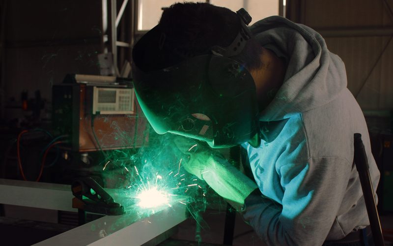 Welder in manufacturing facility