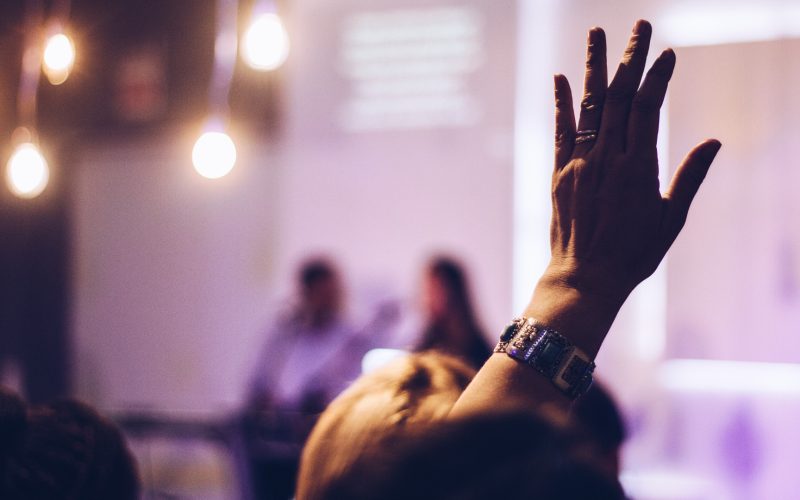 Woman raising hand to speak