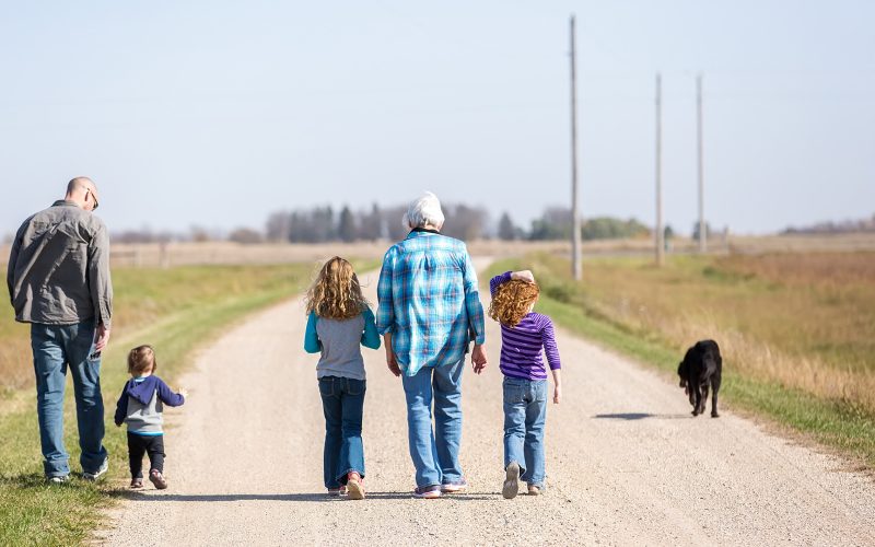 Family Walking Down Rural Gravel Driveway