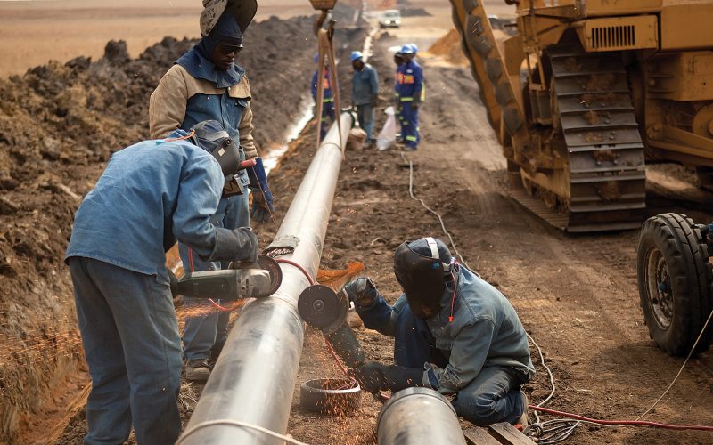 Laborers working on pipeline