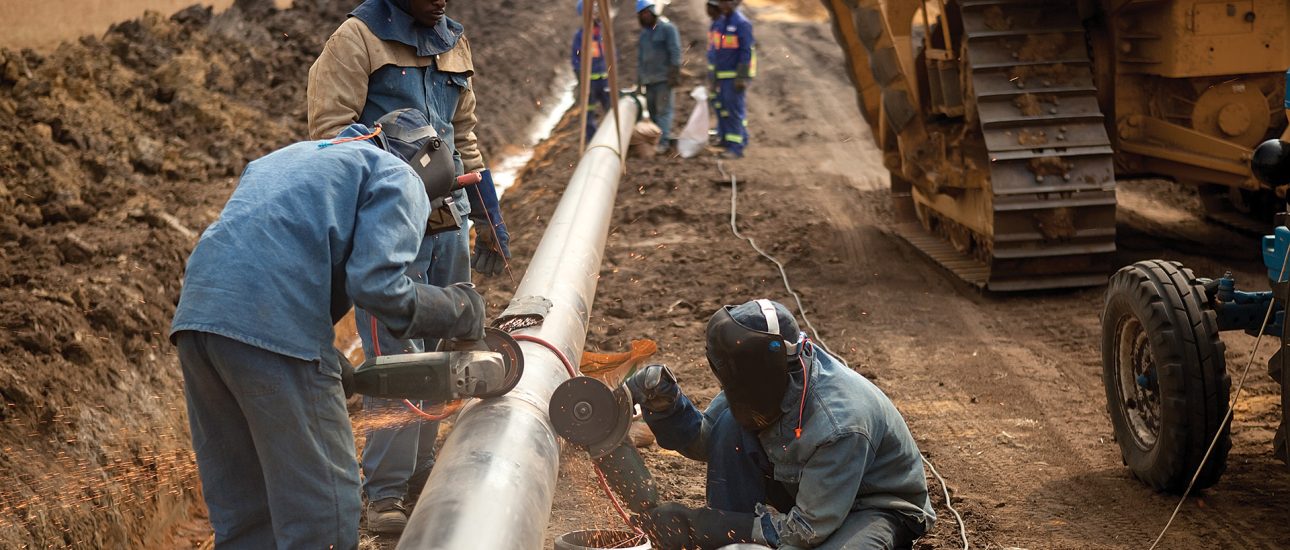 Laborers working on pipeline