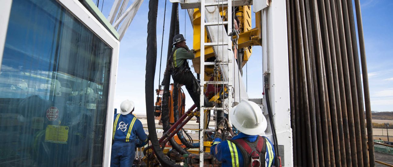 Oil Workers Climb a Rig