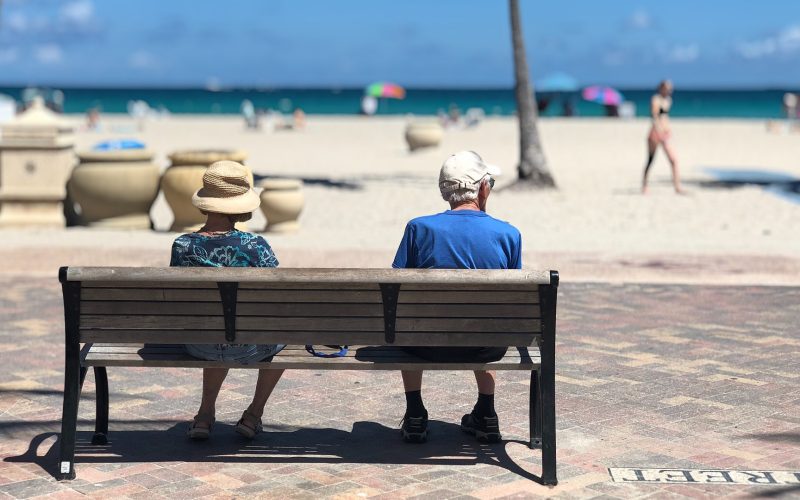 Adults on a beach bench