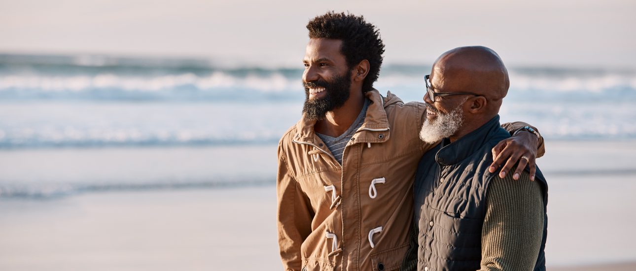 Father and son walking along the beach