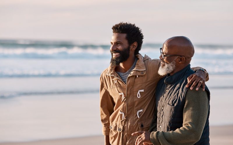 Father and son walking along the beach