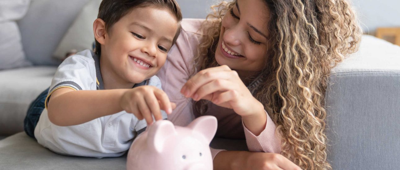 Mother and son saving money in a piggybank