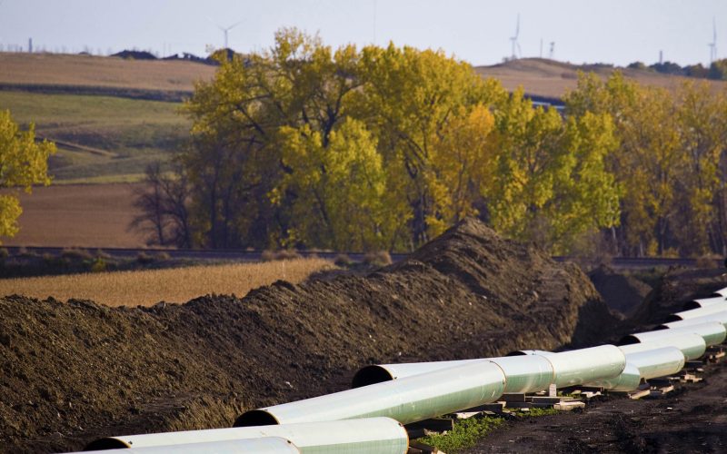 Pipeline construction with wind turbines in the background